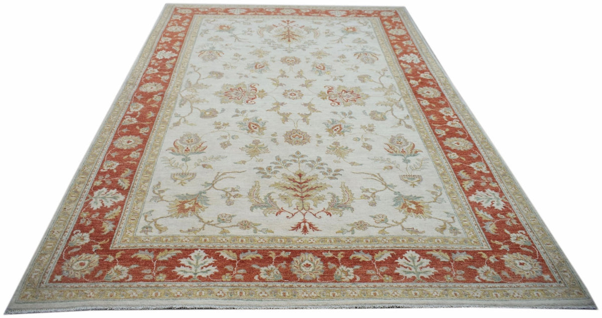 An Afghan Chobi rug featuring a traditional floral pattern in rust and cream tones.