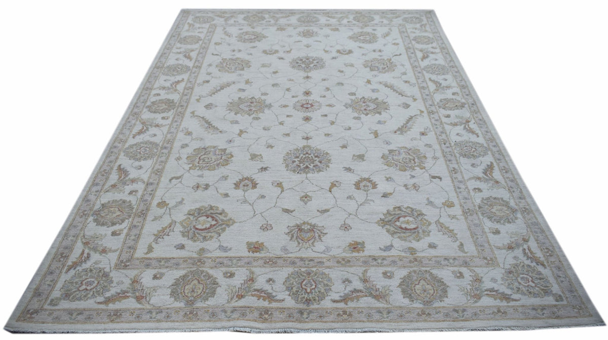 An Afghan Chobi rug featuring a traditional floral pattern in soft, neutral wood tones.
