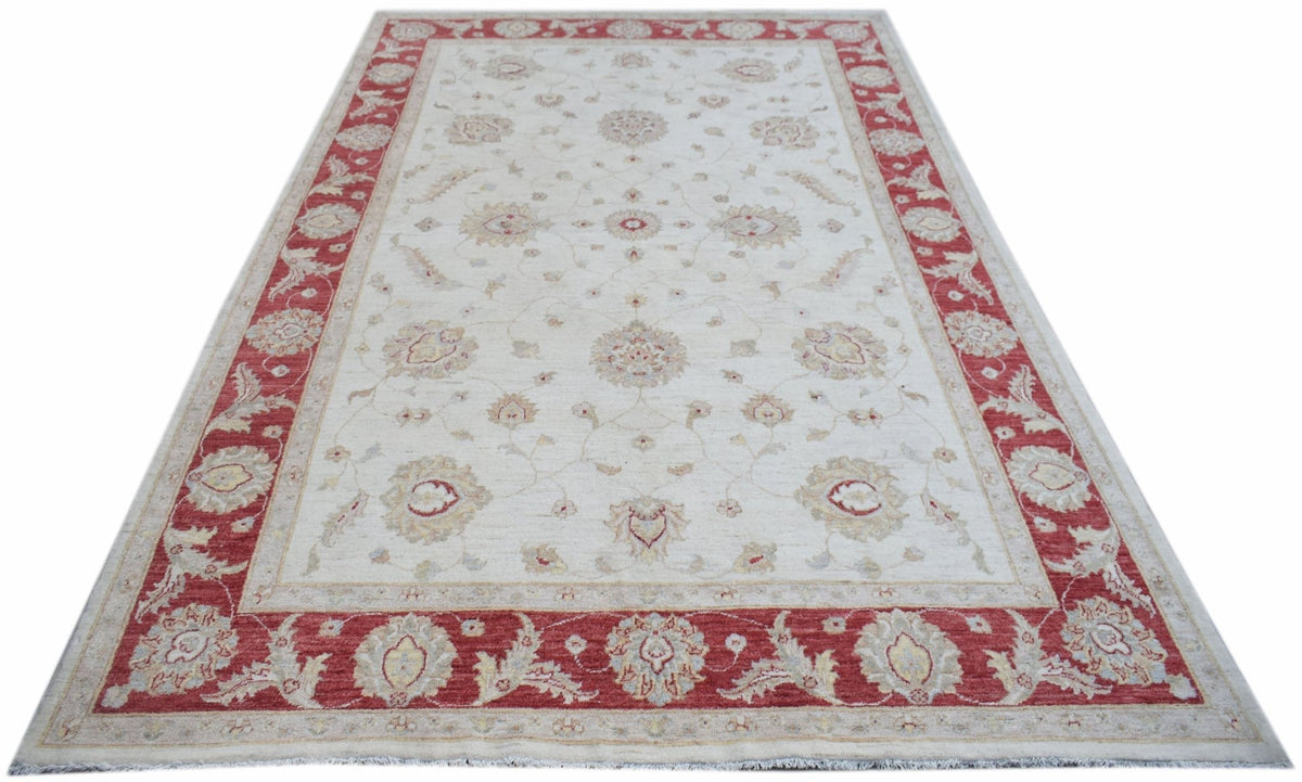 Handwoven Afghan Chobi rug featuring a cream field with floral motifs and a red border.
