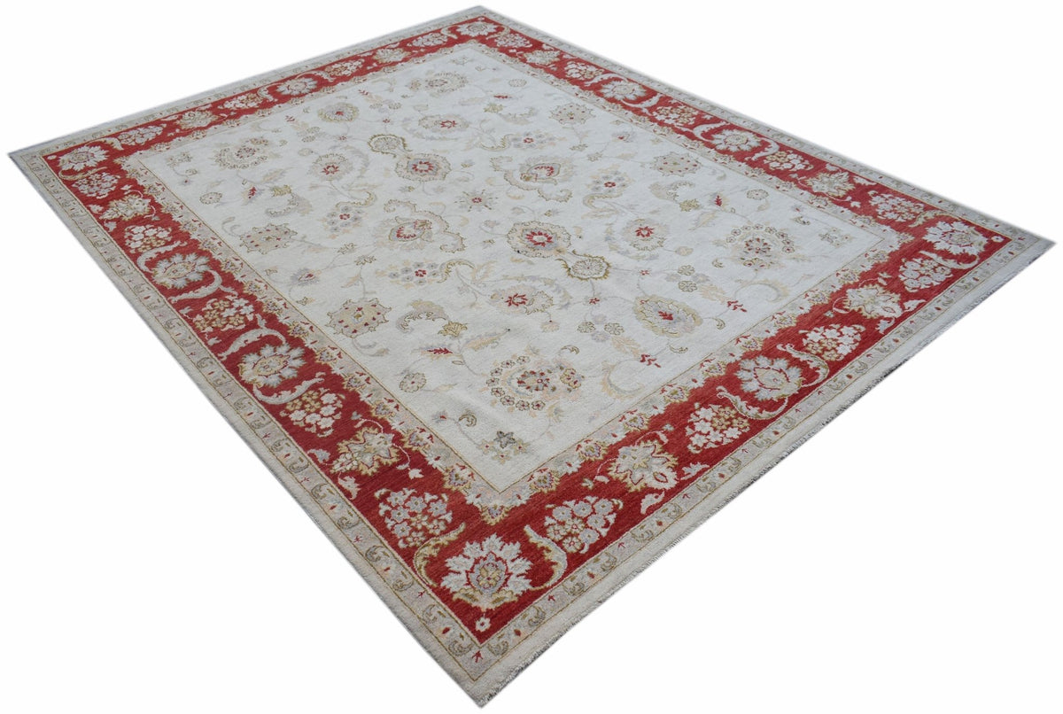 An Afghan Chobi rug featuring a cream field with floral motifs and a wide red border.