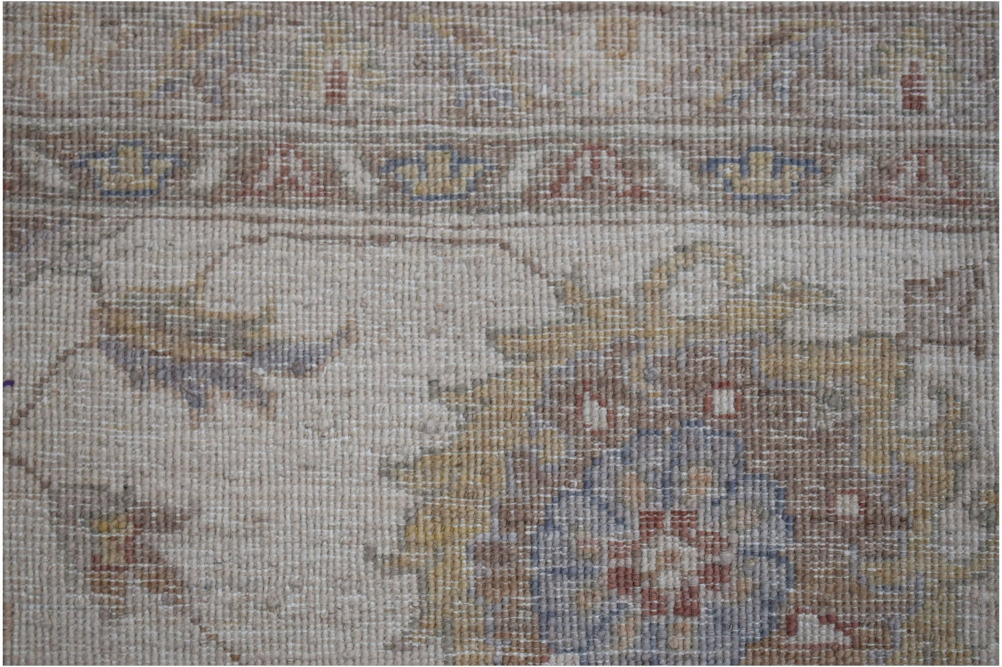 A close-up of an Afghan Chobi rug featuring traditional floral patterns in muted earthy tones.