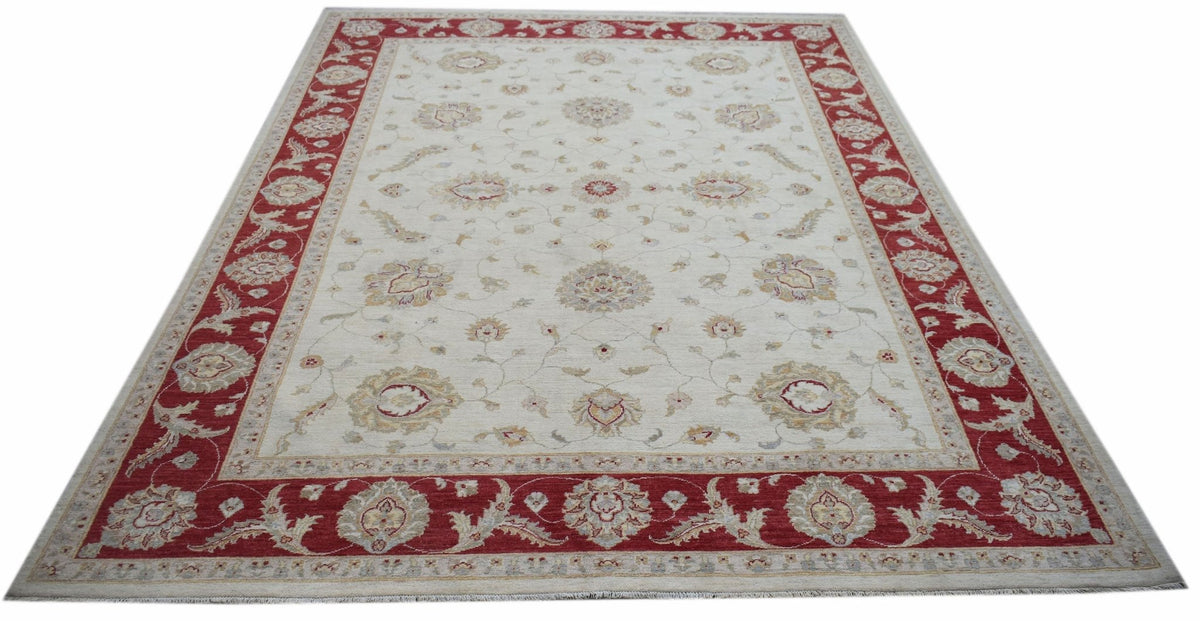 A rectangular Afghan Chobi rug featuring a cream field with floral motifs and a red border.