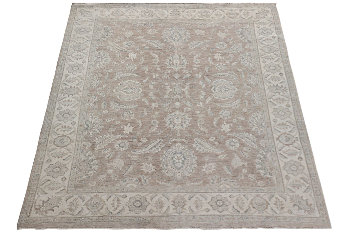 An Afghan Chobi rug featuring a traditional floral pattern in soft beige and grey tones.