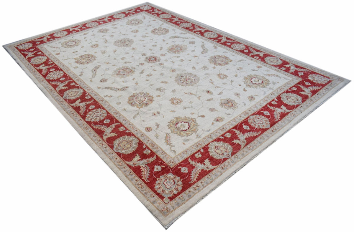 A rectangular Afghan Chobi rug featuring a cream field with floral patterns and a red border.