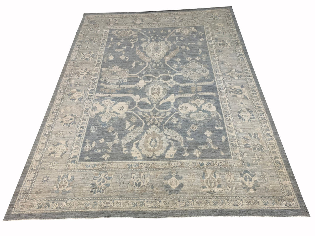 A handmade Afghan Chobi rug featuring a traditional floral pattern in shades of blue and beige.