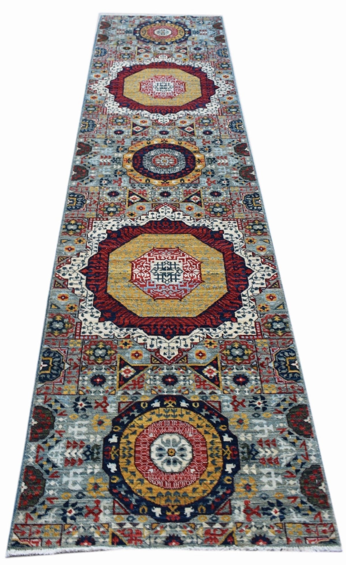 Hand-knotted Afghan Chobi runner featuring a geometric Mamluk design in jewel-toned red, gold, and blue on a grey field.