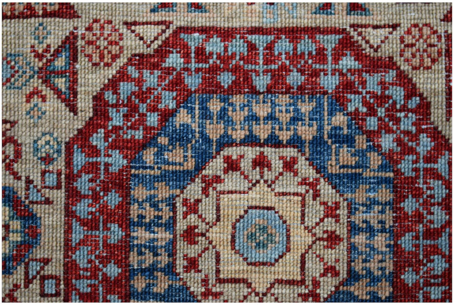 A close-up of an Afghan Chobi runner featuring a traditional Mamluk medallion in red and blue.