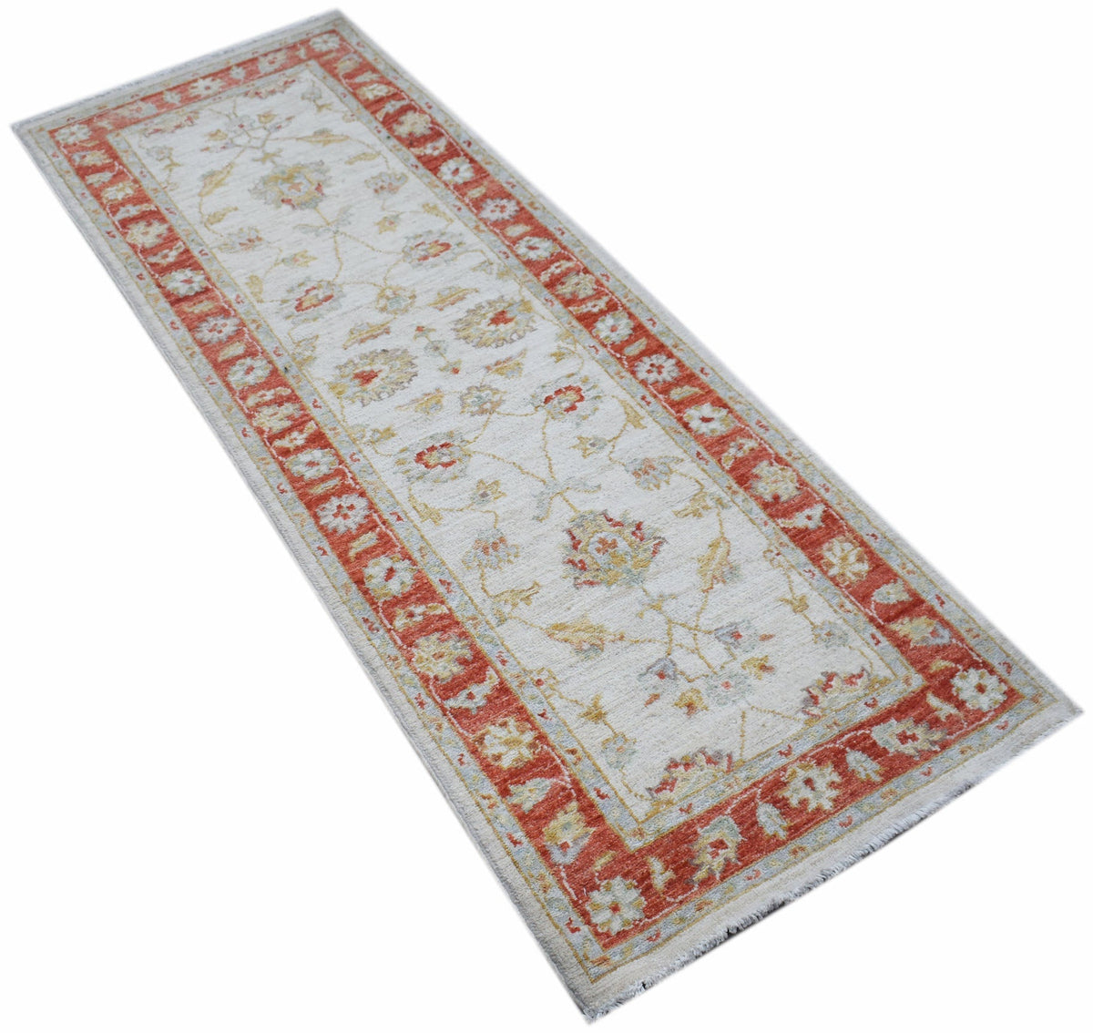 A handmade Afghan Chobi runner featuring a traditional floral pattern in red and cream tones.