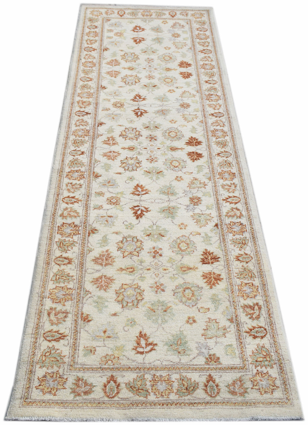 A handmade Afghan Chobi runner rug featuring a traditional floral pattern in soft earth tones.