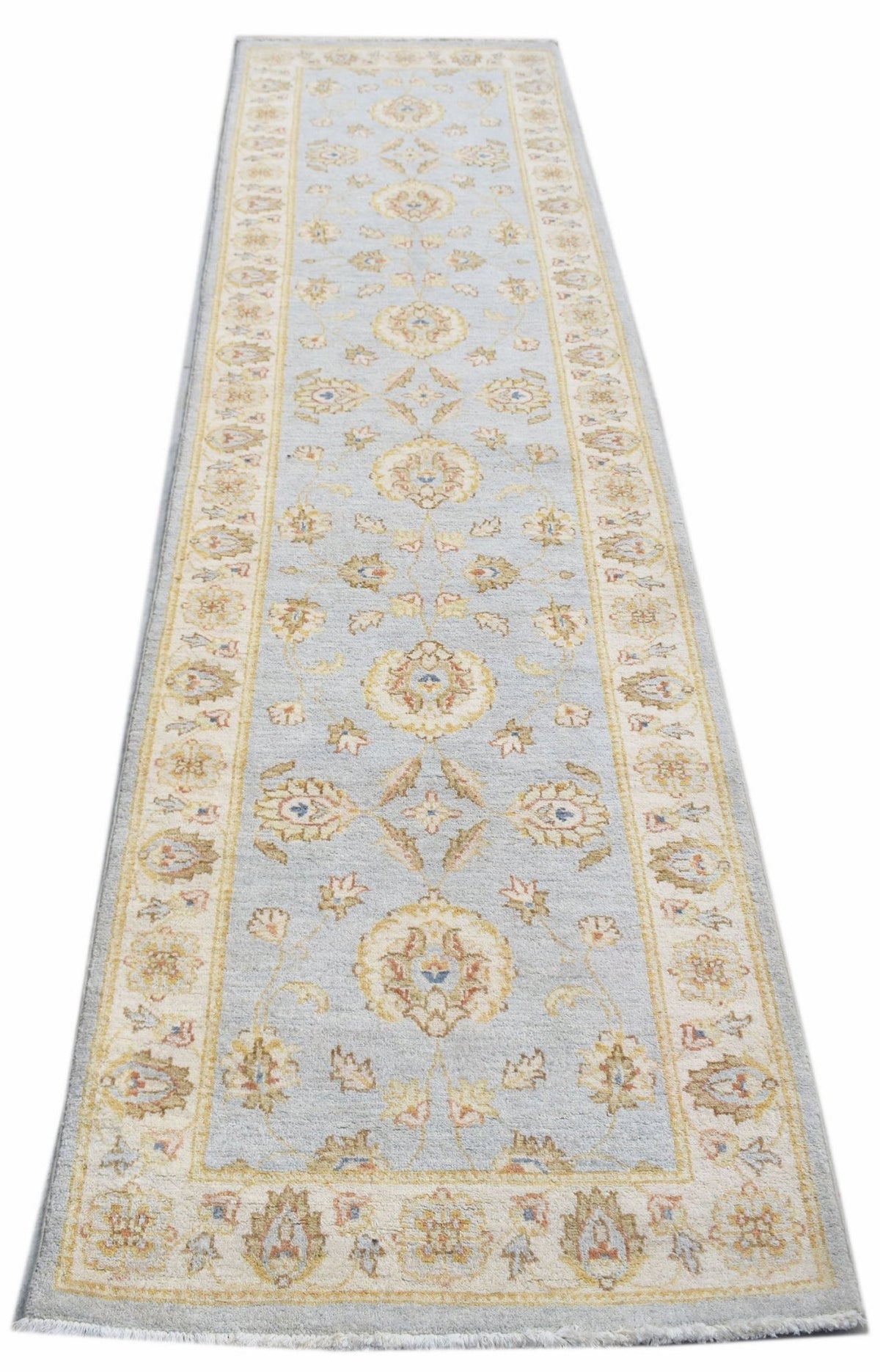 Hand-knotted Afghan Chobi runner in light blue with a repeating floral pattern and cream border.