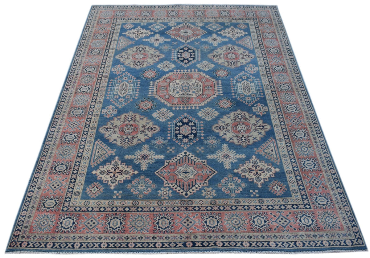Handmade Afghan Kazakh rug featuring traditional geometric motifs in blue, pink, and cream tones.