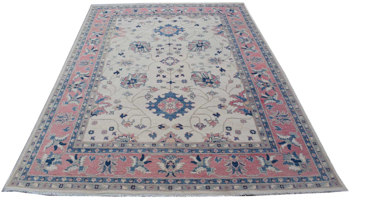 Handmade Afghan Kazakh rug featuring traditional floral motifs in pink and blue on a cream field.