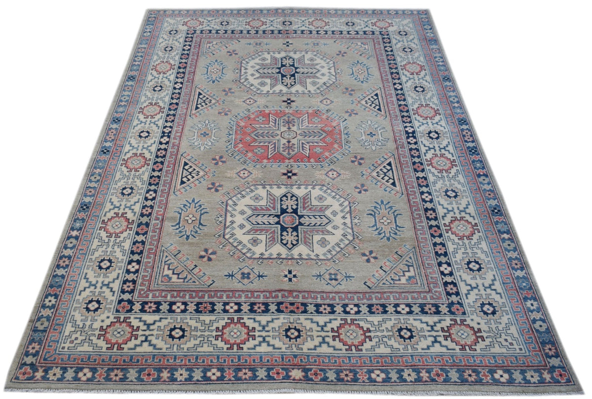 Handmade Afghan Kazakh rug featuring traditional geometric motifs in blue, red, and beige wool.