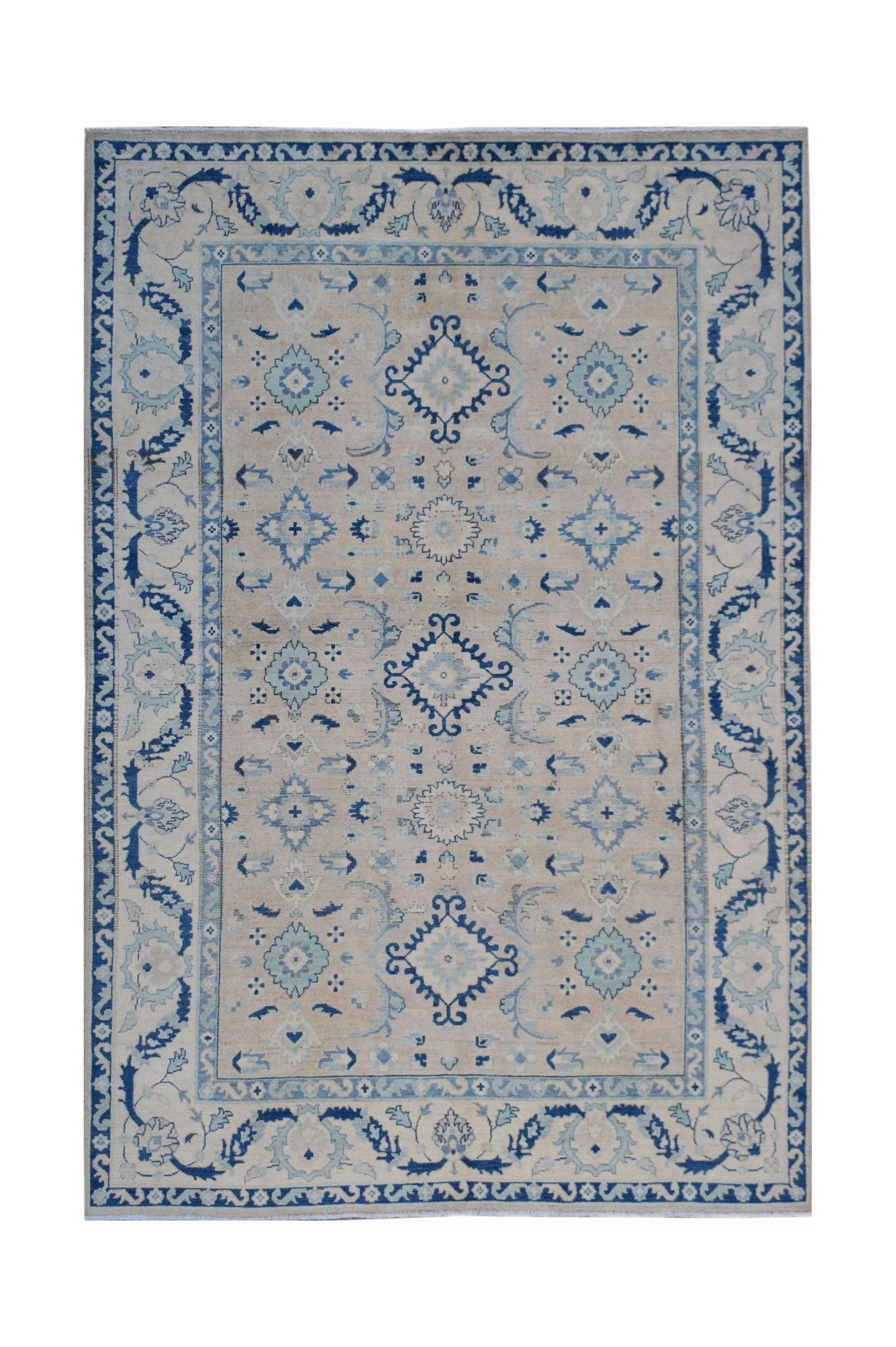 Handmade Afghan Kazakh rug featuring a traditional blue and cream geometric floral pattern.