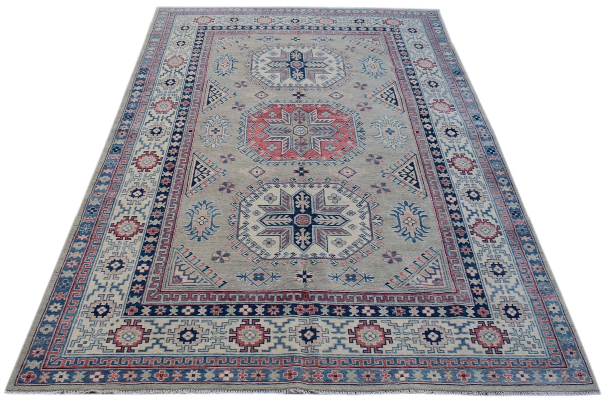 Handmade Afghan Kazakh rug featuring traditional geometric motifs in blue, red, and cream tones.