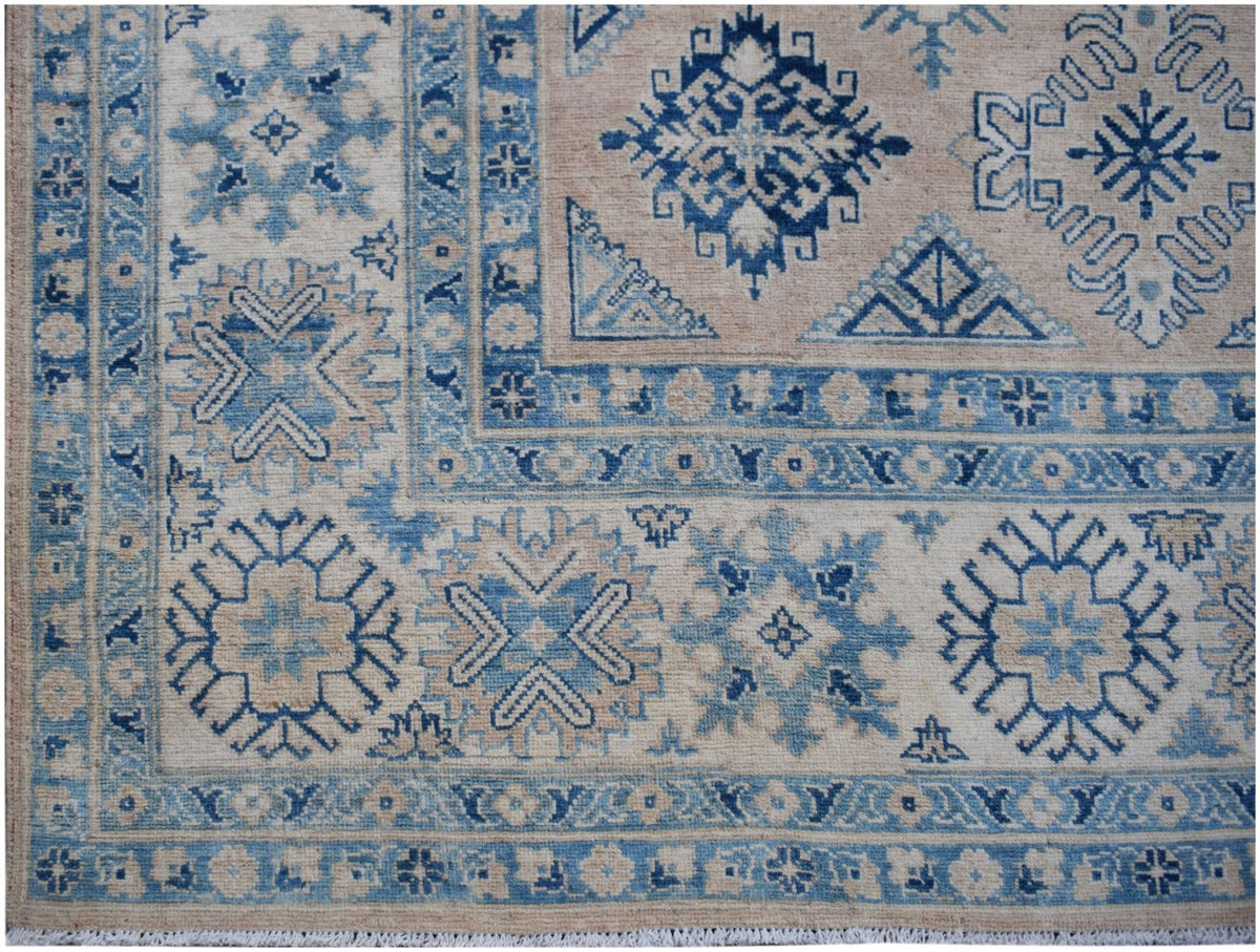 Handmade Afghan Kazakh rug featuring traditional blue and beige geometric patterns.