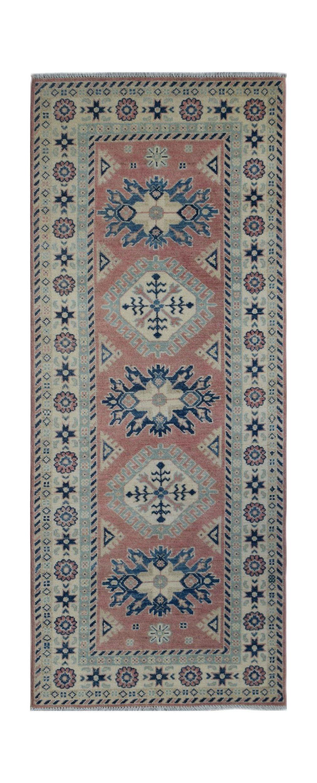 Handmade Afghan Kazakh runner rug featuring traditional geometric motifs in pink, blue, and cream.