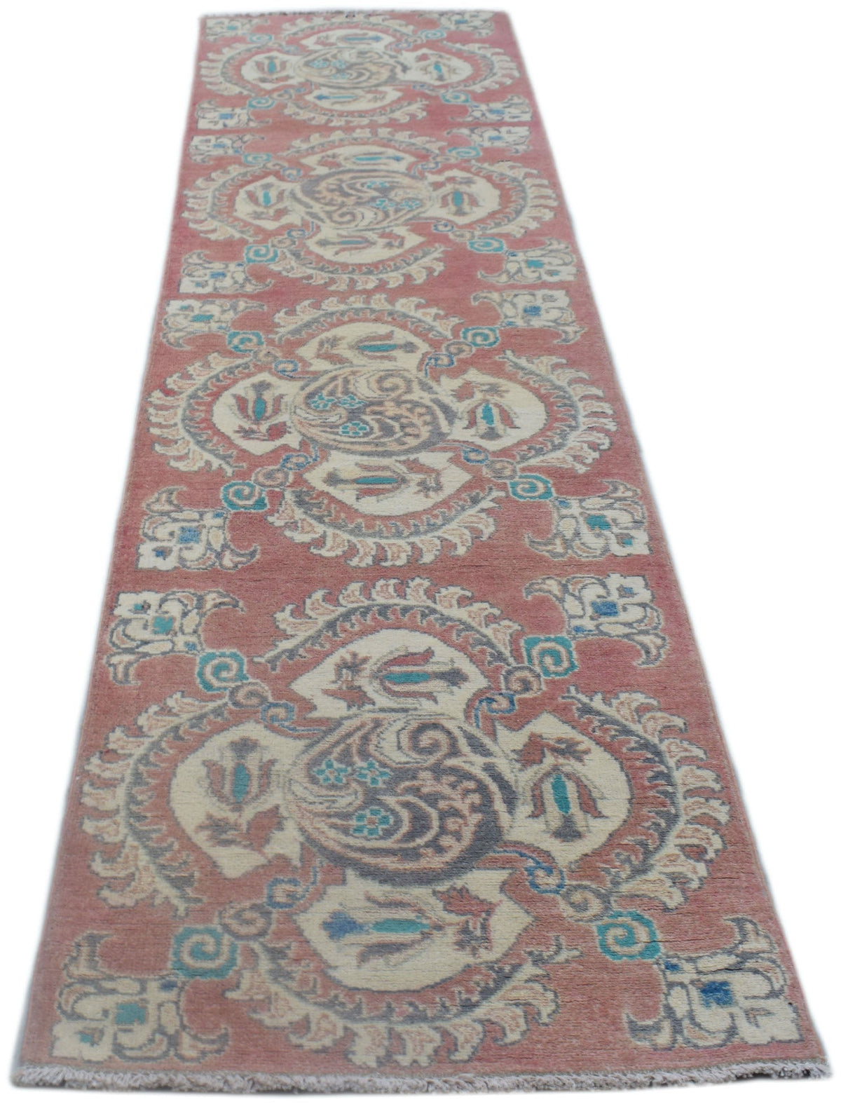 A handmade Afghan Kazakh runner rug featuring traditional floral motifs in red, cream, and blue.