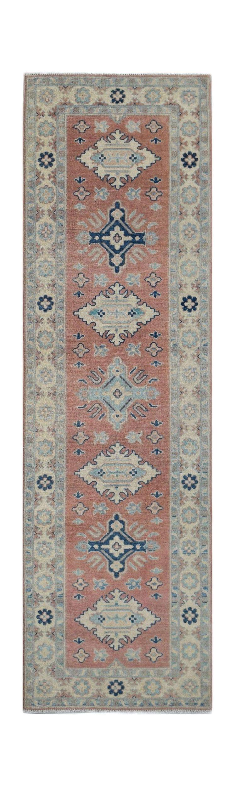 Handmade Afghan Kazakh runner rug featuring traditional geometric motifs in terracotta and blue.