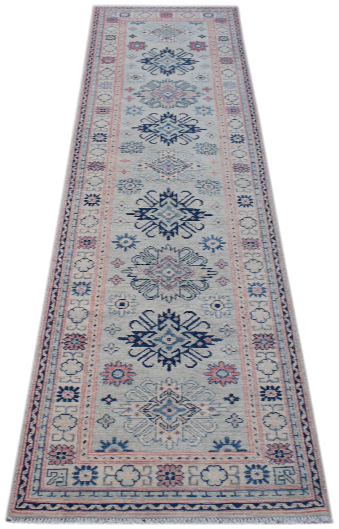 A handmade Afghan Kazakh runner rug featuring traditional geometric motifs in blue and pink.