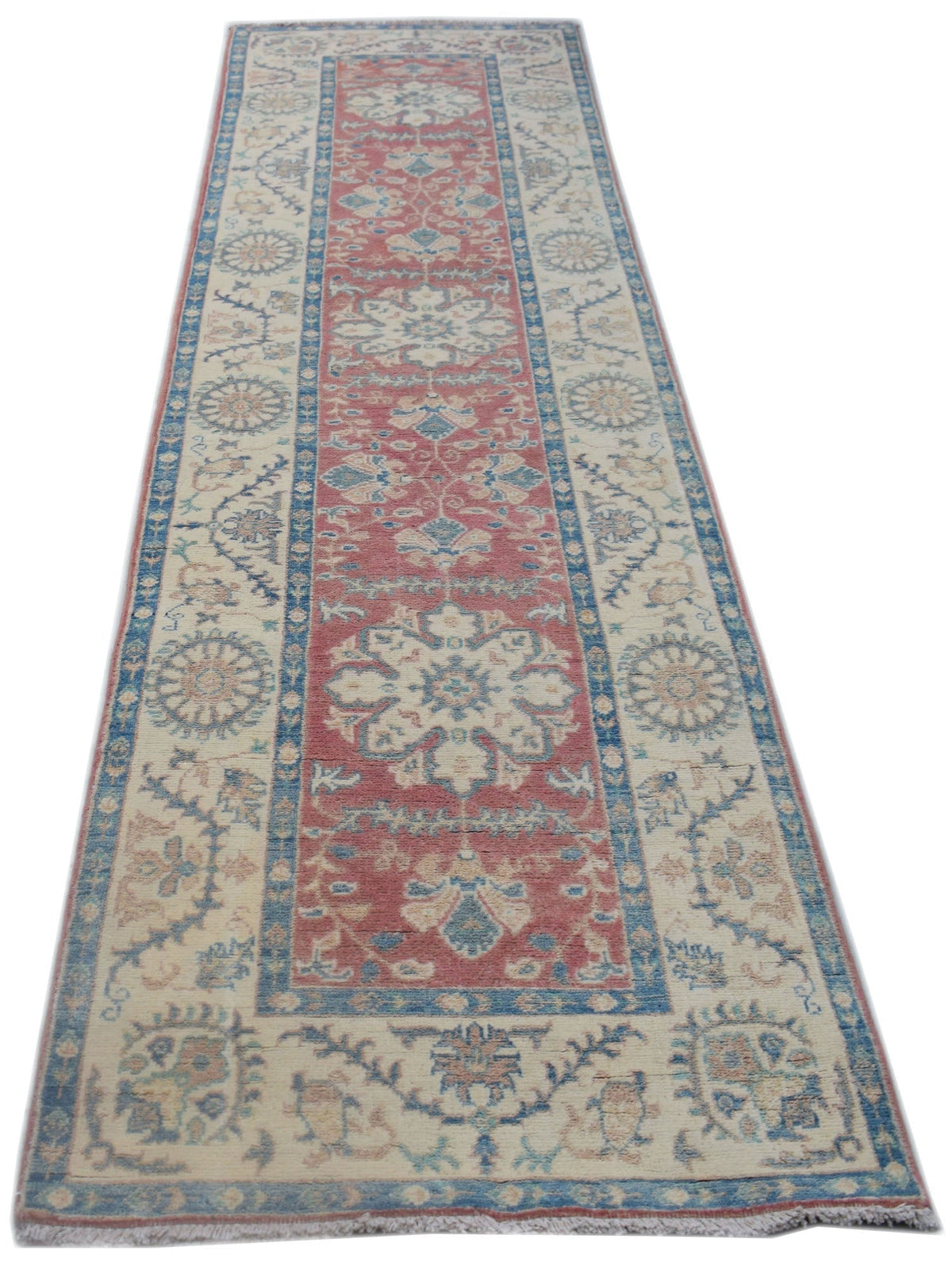 A handmade Afghan Kazakh runner rug featuring traditional floral motifs in red, blue, and cream.