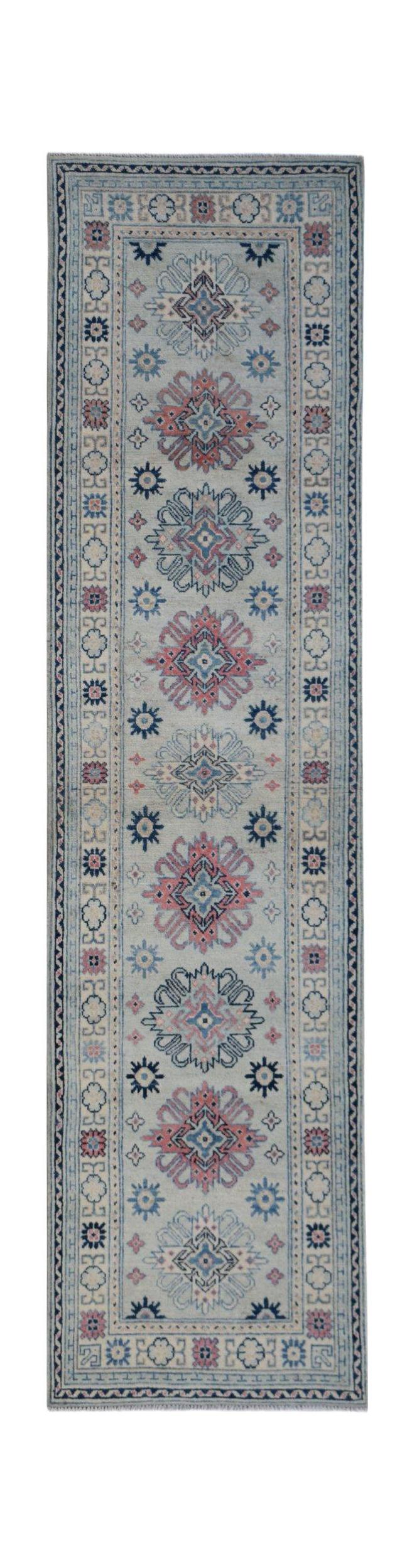 A handmade Afghan Kazakh runner rug featuring traditional geometric motifs in blue and pink tones.