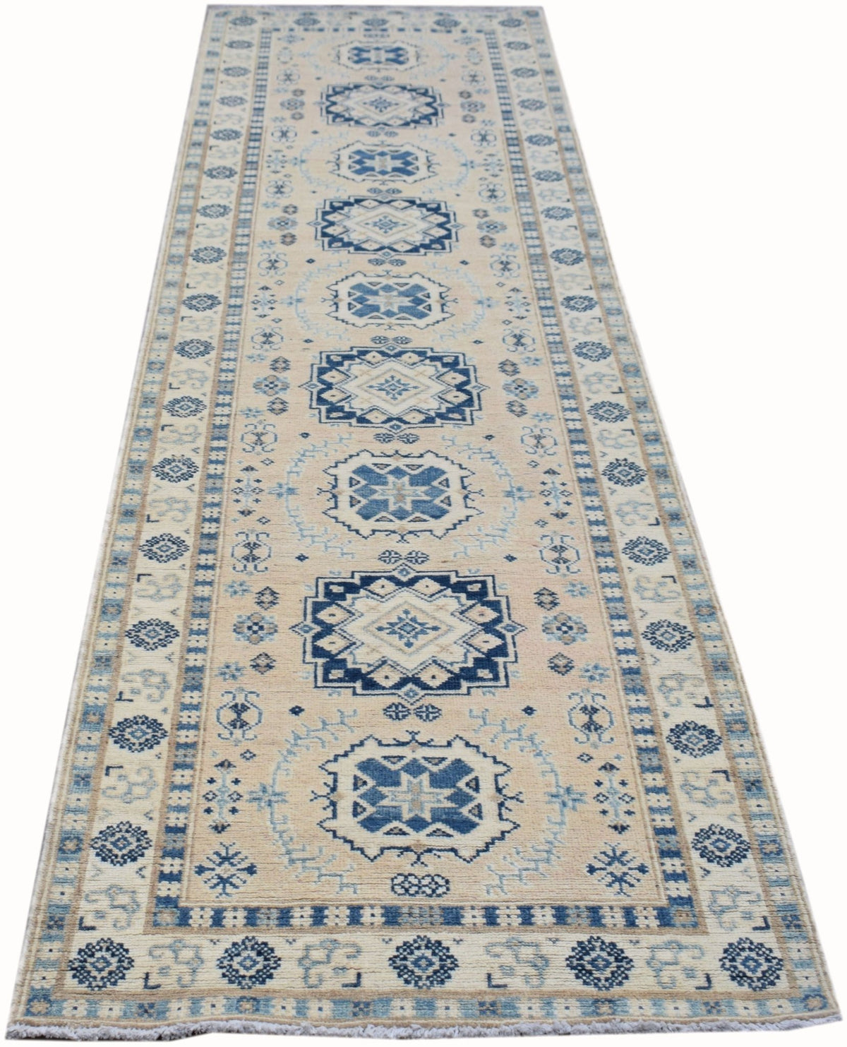 Afghan Kazakh runner with blue geometric medallions on a cream field, featuring intricate borders and a fringed edge.