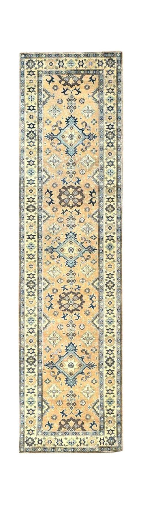 Handmade Afghan Kazakh runner rug featuring a beige field with blue and grey geometric motifs.