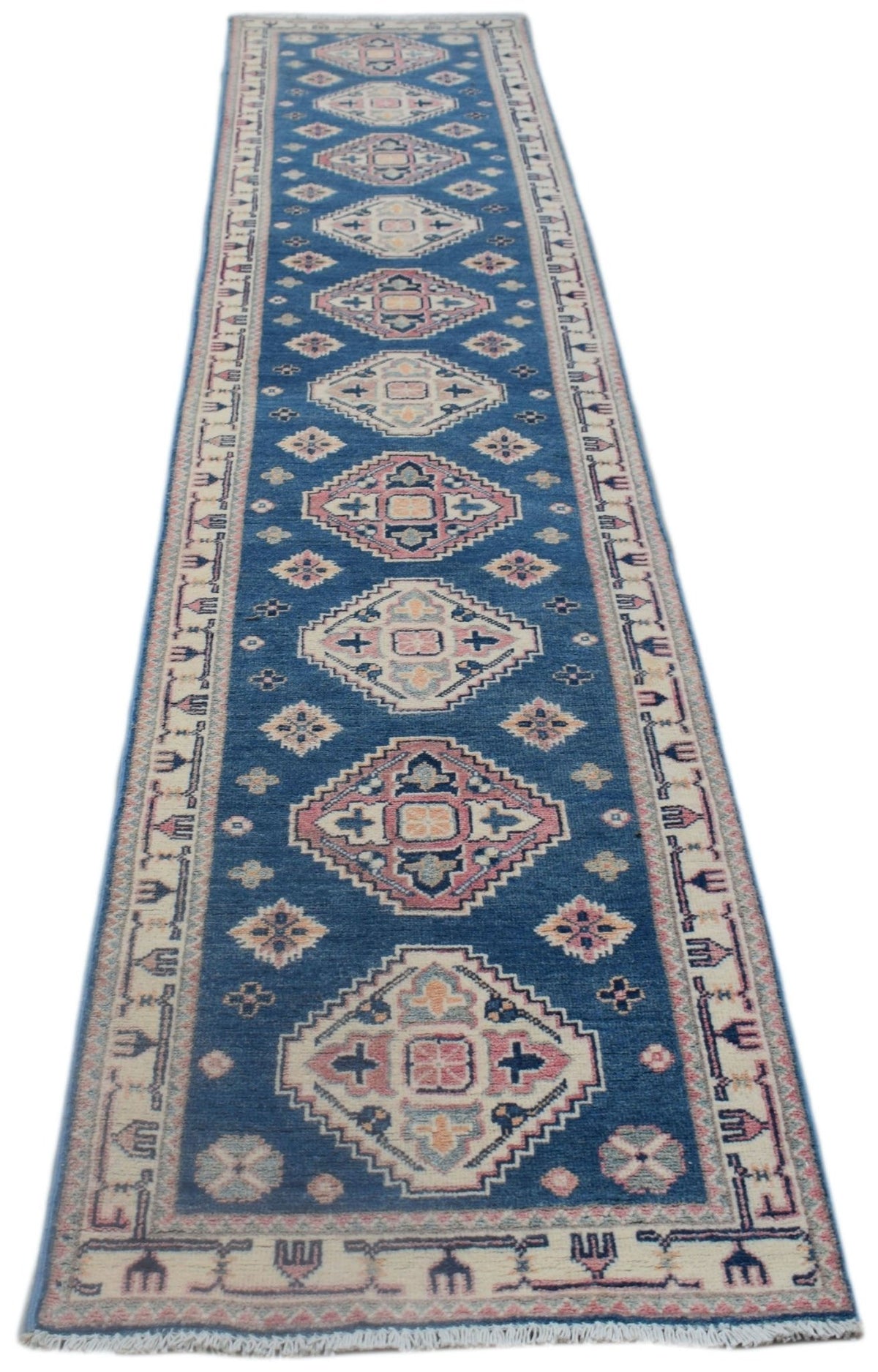 A handmade Afghan Kazakh runner rug featuring traditional geometric motifs in blue and pink tones.