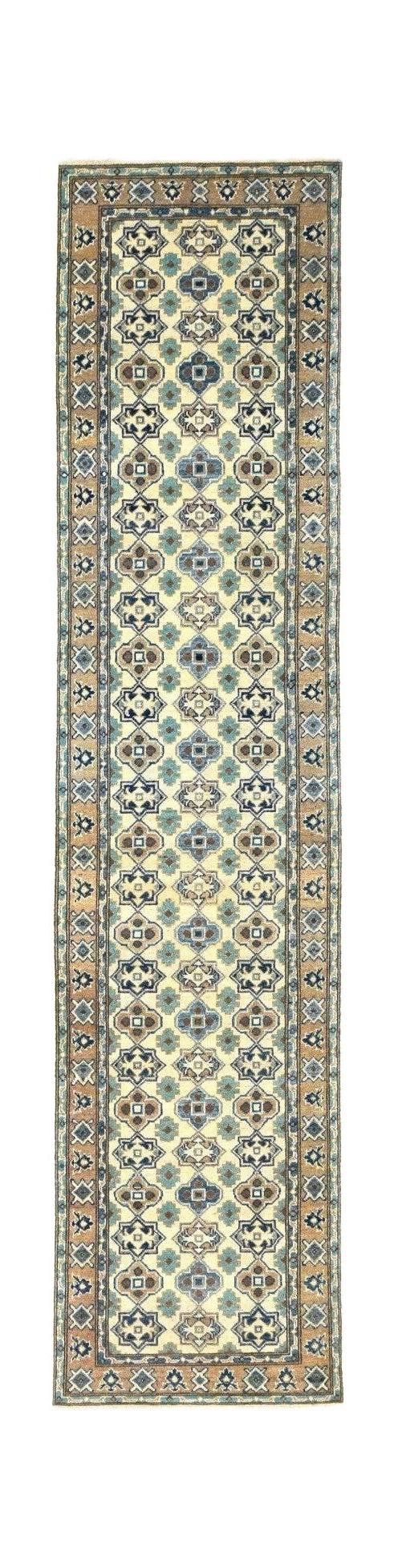 A handmade Afghan Kazakh runner rug featuring a geometric pattern in blue, beige, and brown tones.
