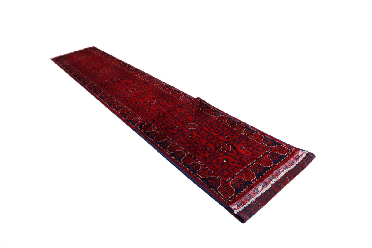 Hand-spun wool Afghan Khal Mohammadi runner in deep red with geometric guls and a fringed edge.