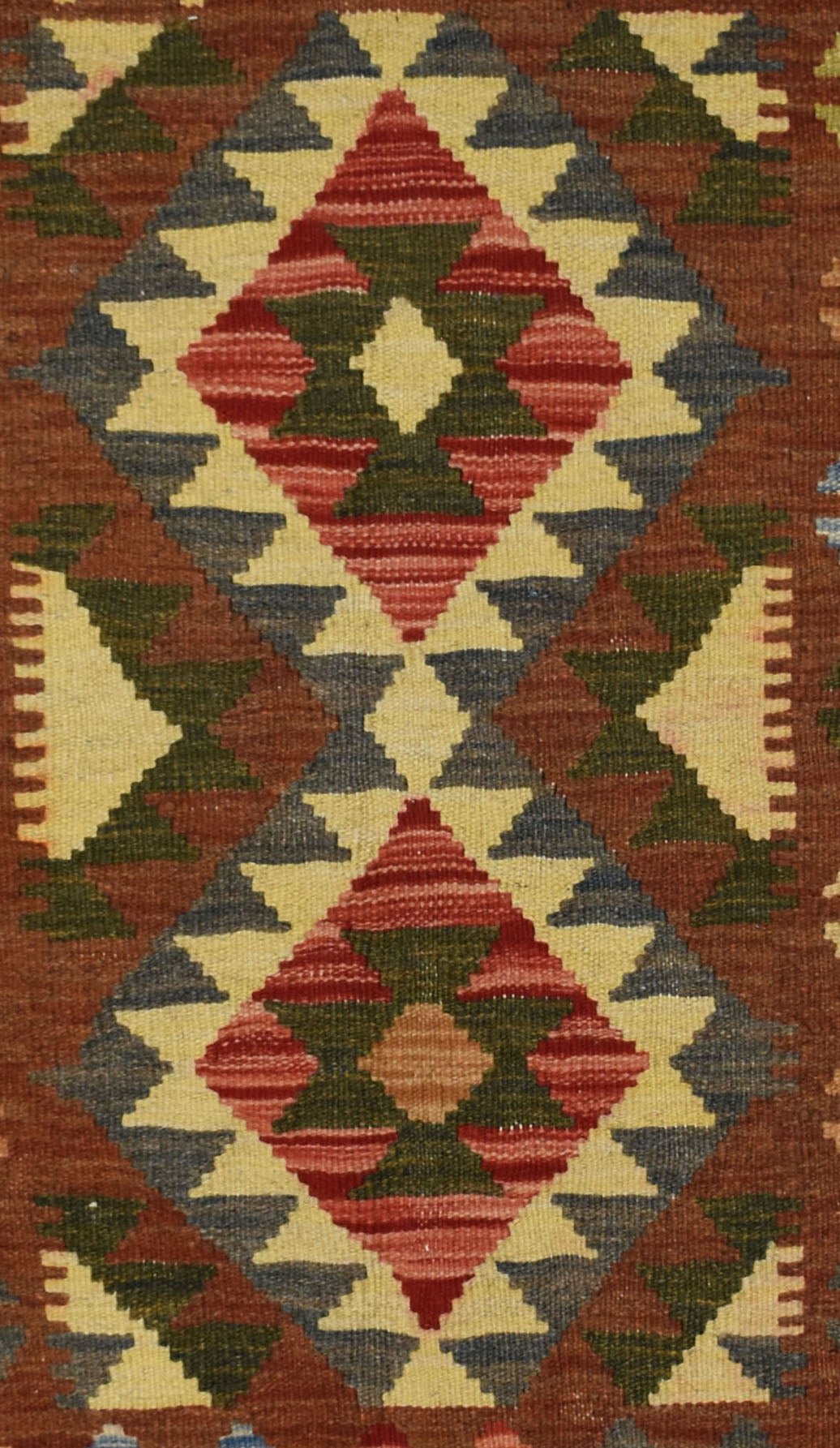 Handmade Afghan Maimana kilim rug featuring a geometric diamond pattern in red, green, and cream.