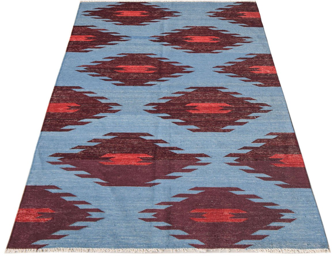 Afghan Maimana Kilim with a blue background and geometric red and burgundy patterns.