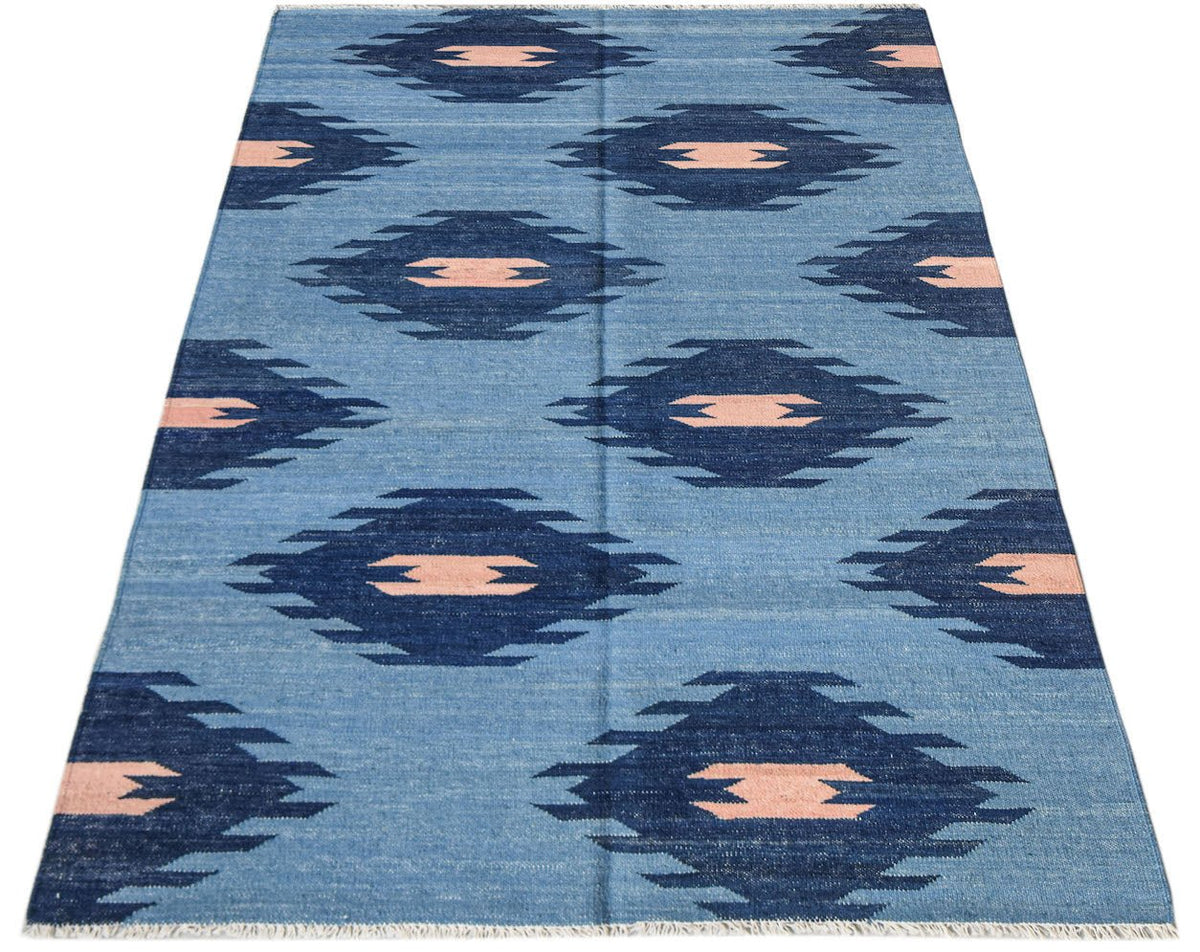 Afghan Maimana Kilim with a blue background and repeating geometric patterns.
