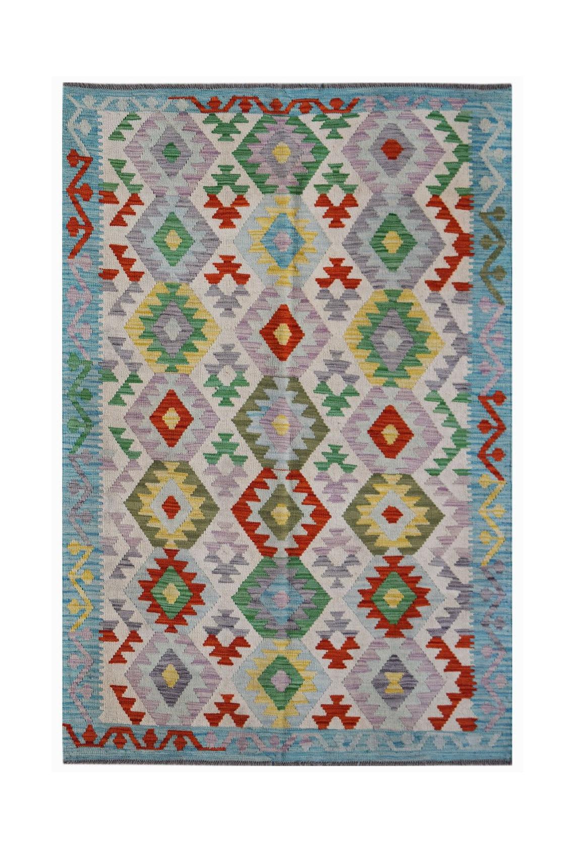 Handwoven Afghan Maimana kilim rug featuring a colorful geometric diamond pattern on a light base.