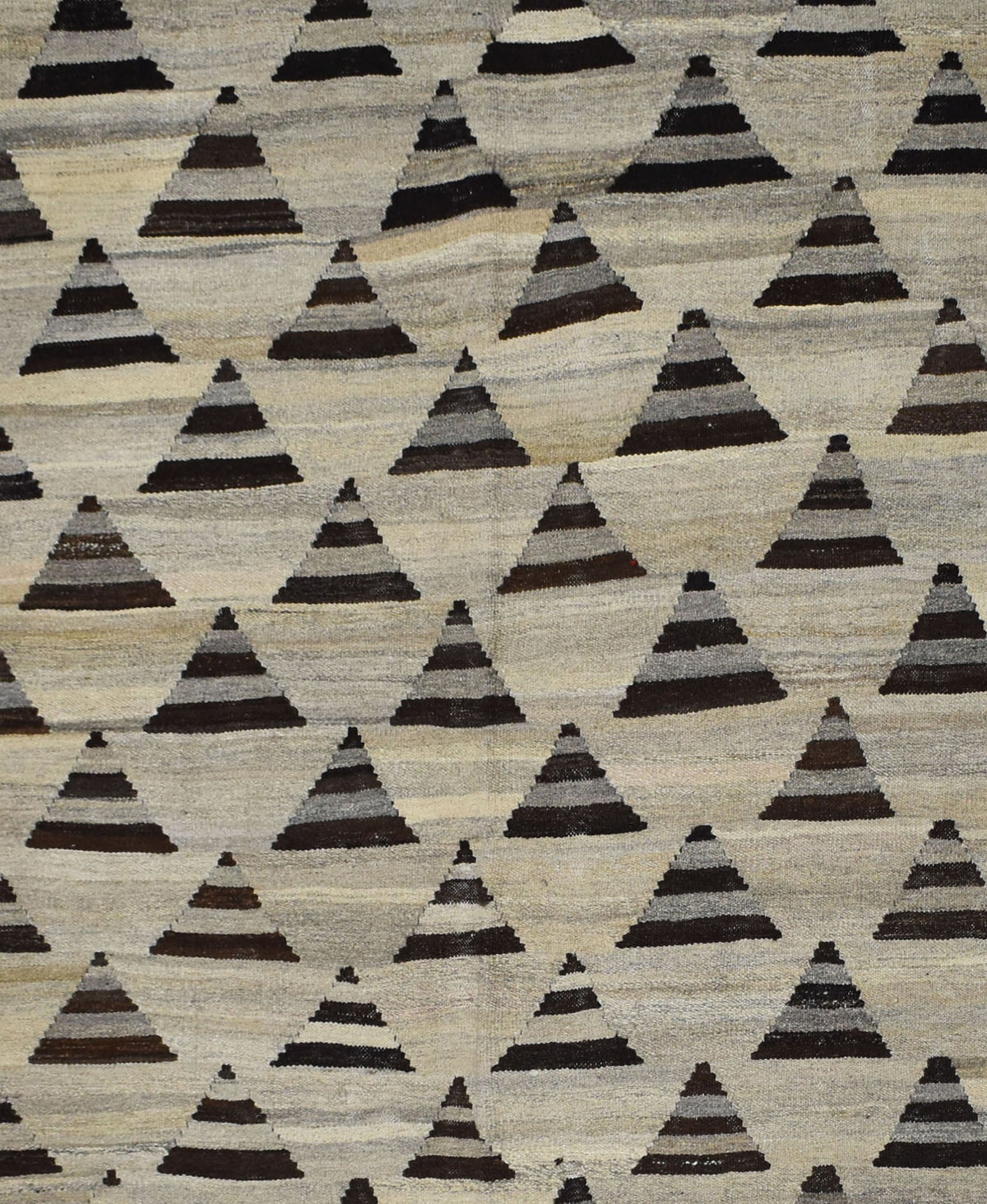 Handmade Afghan Maimana kilim rug featuring a repeating pattern of dark grey triangular motifs.