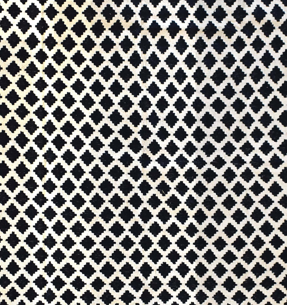 Handmade Afghan Maimana kilim rug featuring a repeating black and white geometric lattice pattern.