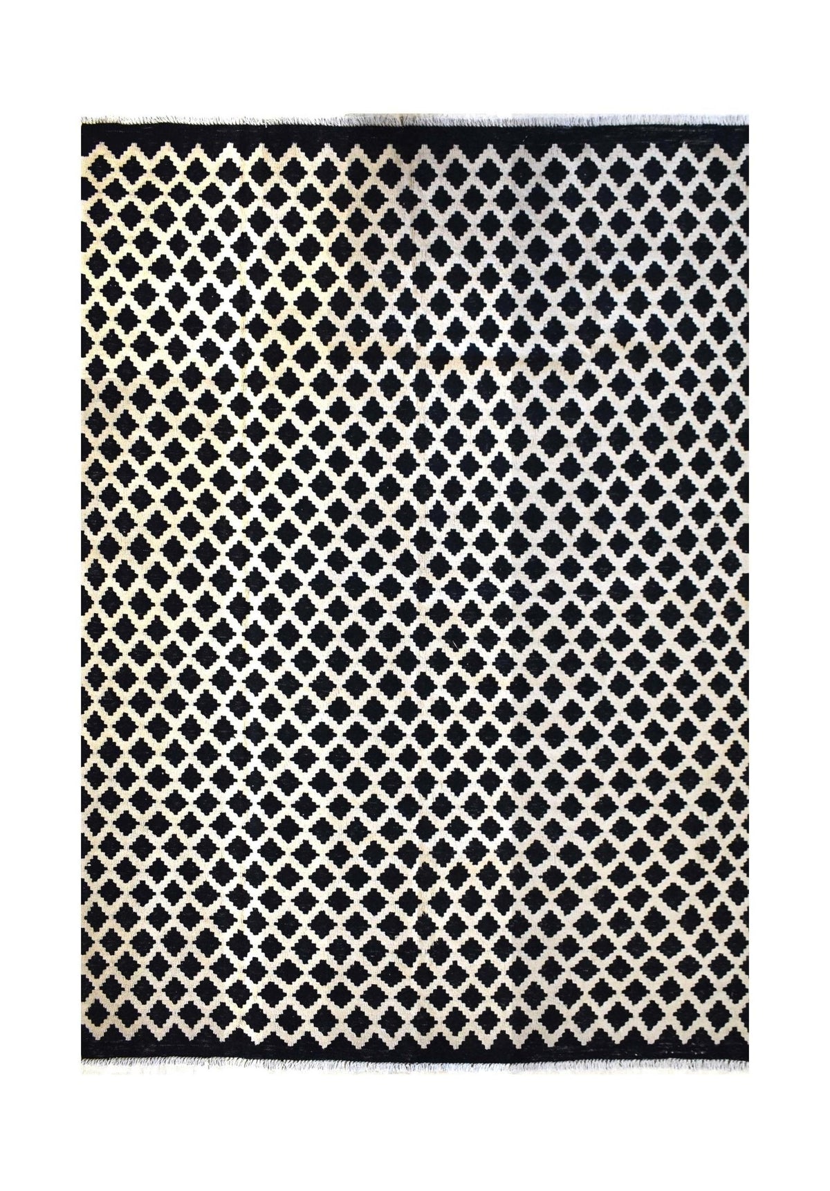 Handmade Afghan Maimana kilim rug featuring a repeating black and white geometric diamond pattern.