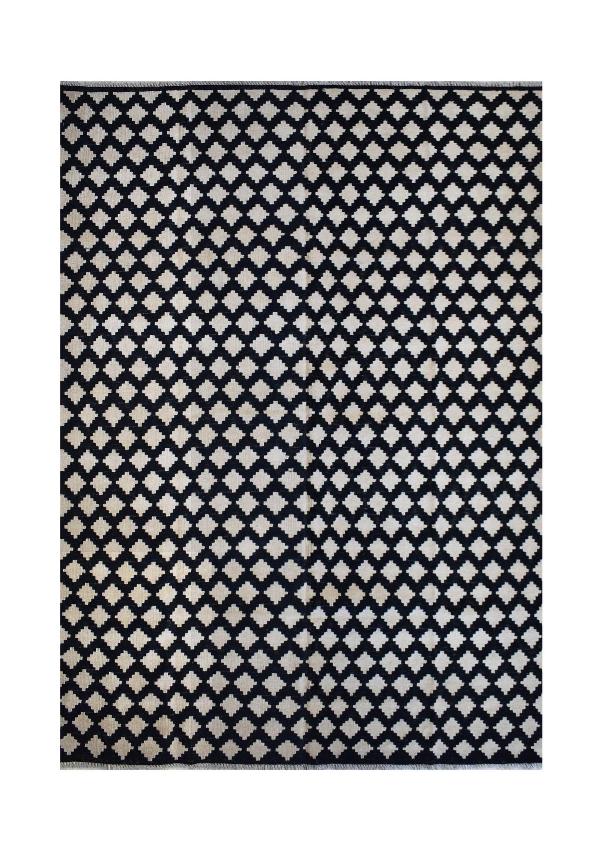 Handmade Afghan Maimana kilim rug featuring a repeating black and cream geometric diamond pattern.