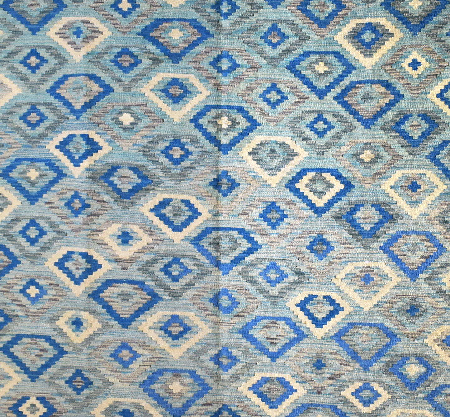 Handmade Afghan Maimana kilim rug featuring a repeating geometric diamond pattern in shades of blue.