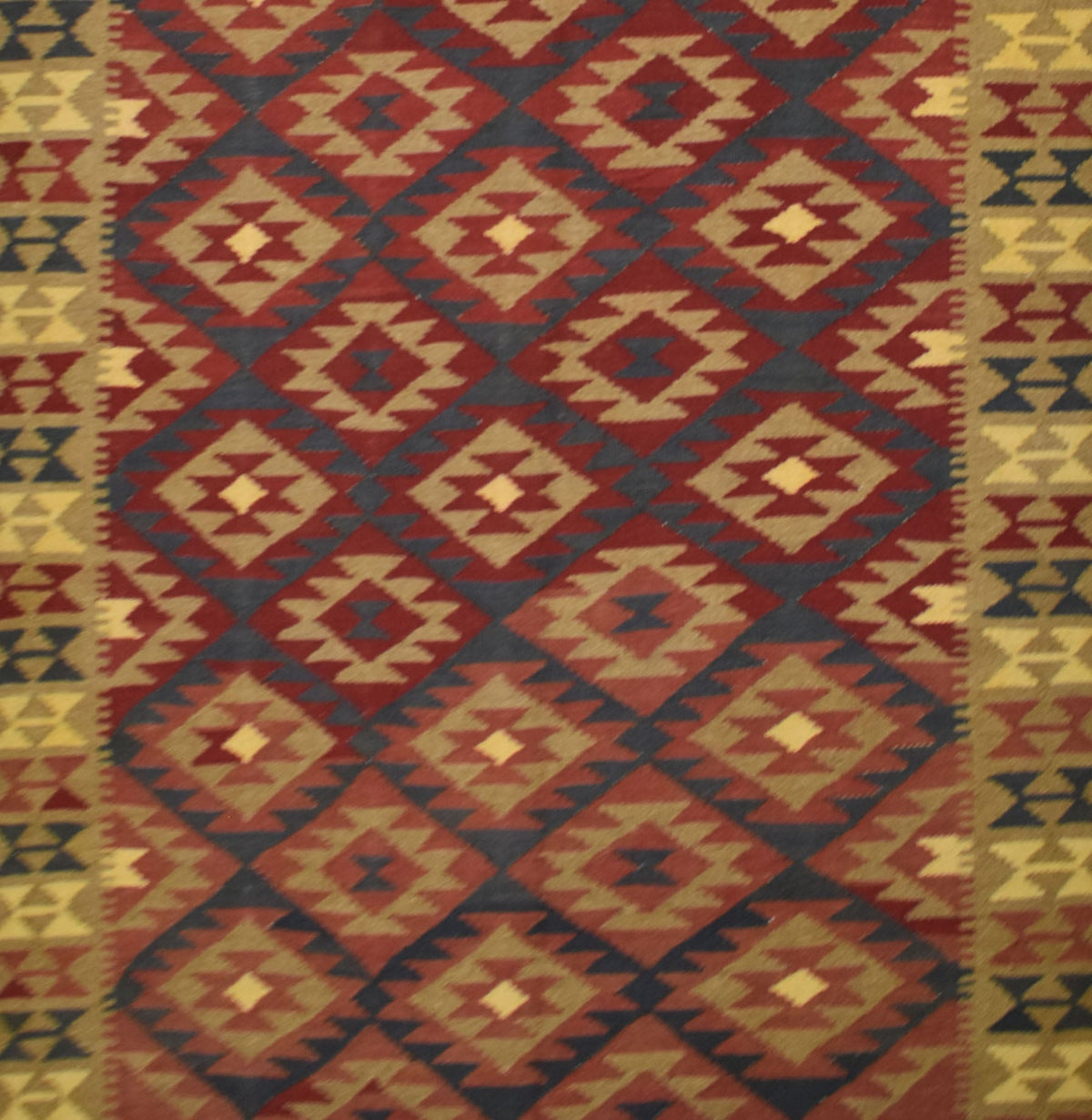 Handmade Afghan Maimana kilim rug featuring a repeating geometric diamond pattern in earthy tones.