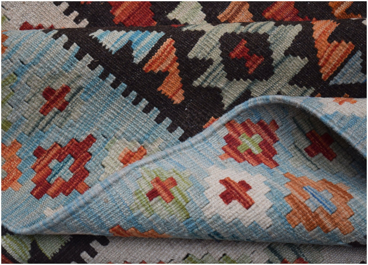 A handwoven Afghan Maimana kilim featuring a geometric pattern in blue, orange, and red wool.