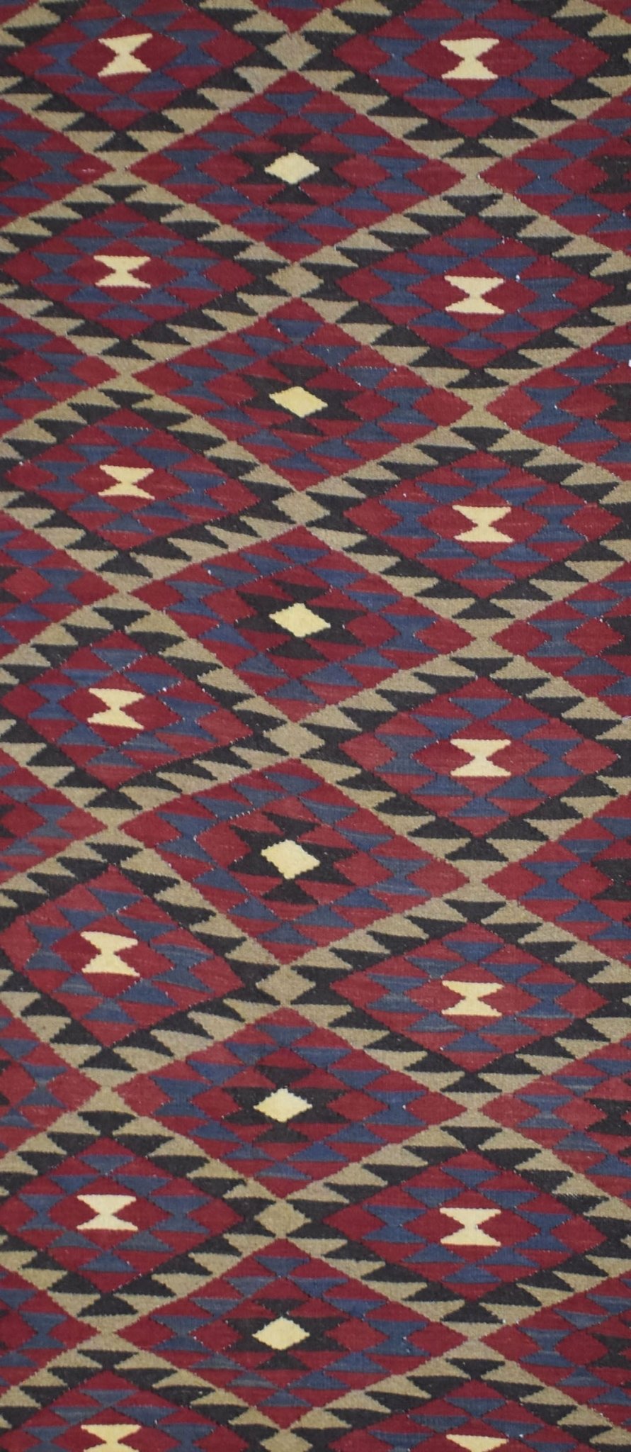 Handmade Afghan Maimana kilim rug featuring a geometric diamond pattern in red, blue, and tan.