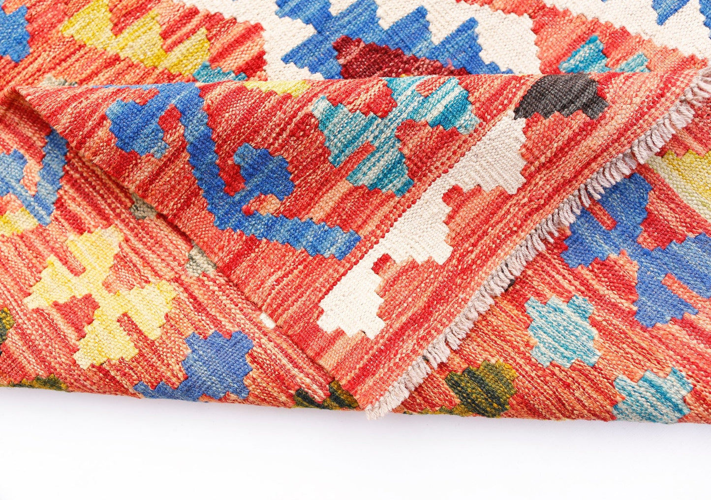 A handwoven Afghan Maimana kilim rug featuring a vibrant geometric pattern in wool.