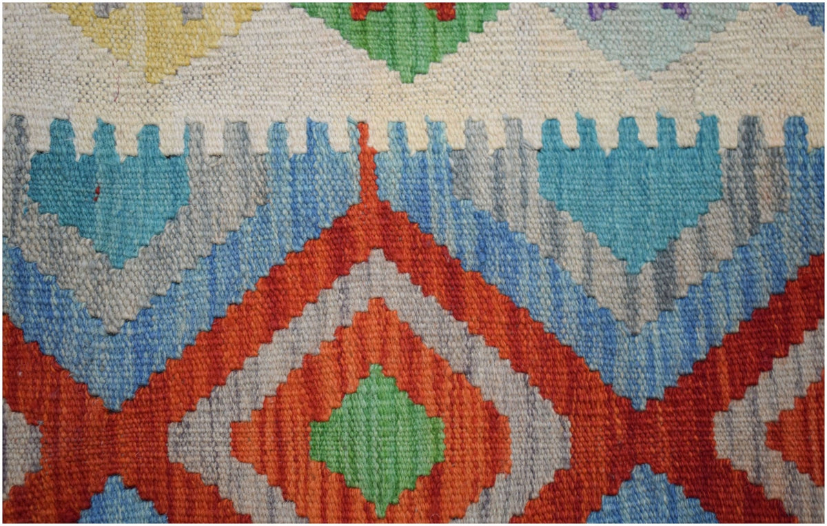 Handwoven Afghan Maimana kilim rug featuring a vibrant geometric diamond pattern in wool.