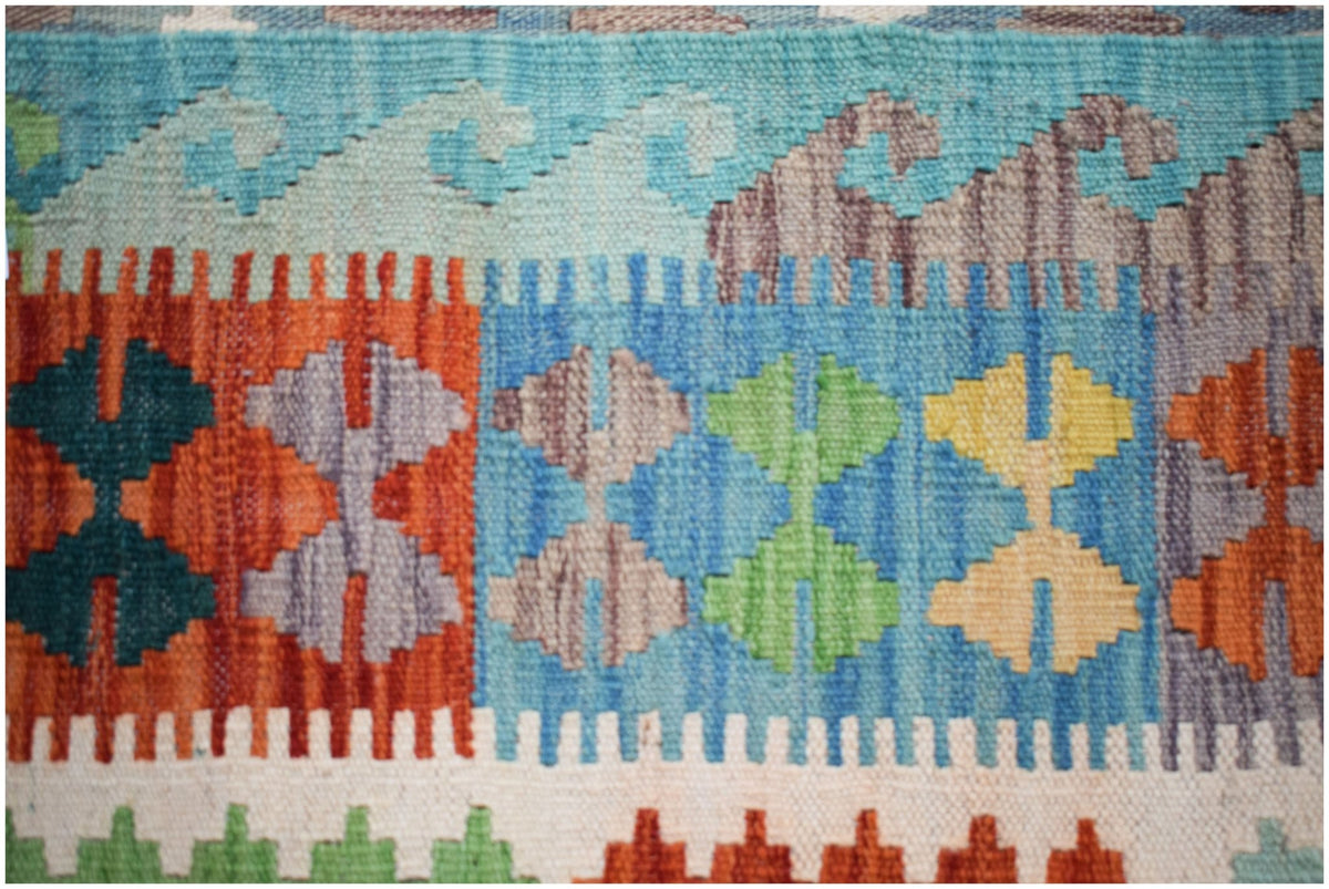 Handwoven Afghan Maimana kilim featuring colorful geometric patterns and a flatweave wool texture.