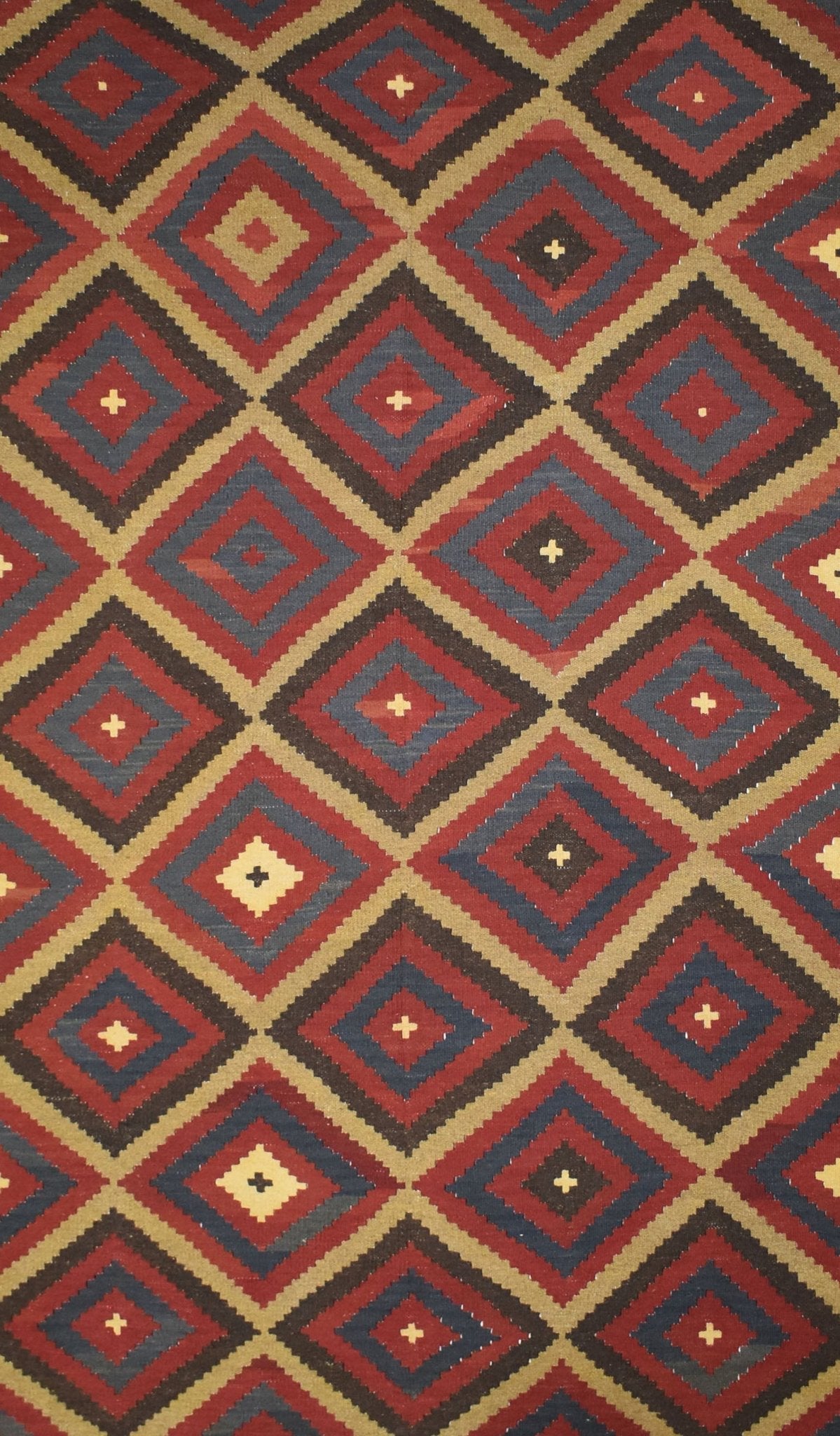 Handmade Afghan Maimana kilim rug featuring a repeating geometric diamond pattern in rich colors.