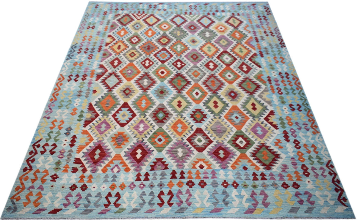 Handwoven Afghan Maimana kilim featuring a colorful geometric diamond pattern on a light blue base.
