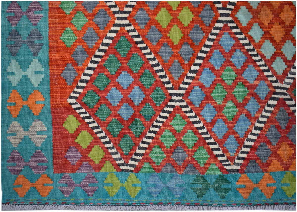 Handwoven Afghan Maimana kilim rug featuring a vibrant geometric diamond pattern in wool.