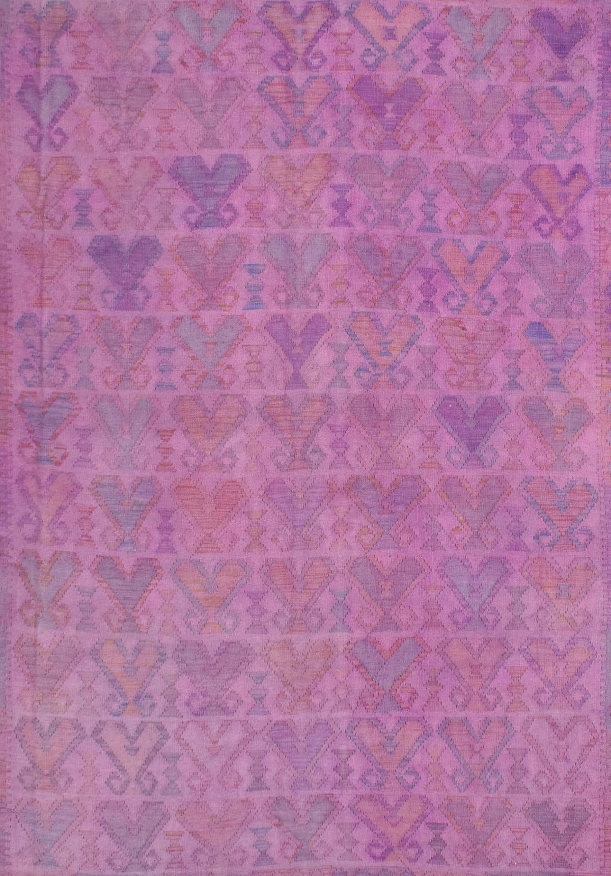 Handmade Afghan Maimana kilim rug featuring a repeating geometric pattern in shades of pink.